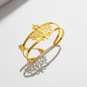 Side angle view of autumn leaf bracelet showing dimensional depth and curved cuff structure with safety chain