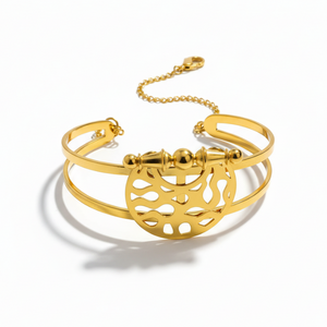 Heritage Dome Bracelet - 24K gold plated stainless steel bangle with circular geometric cutout pattern and ornate barrel clasp, three-quarter view on white background