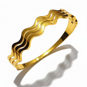 Golden wavy bangle bracelet with clasp closure - premium jewelry by OSHAS