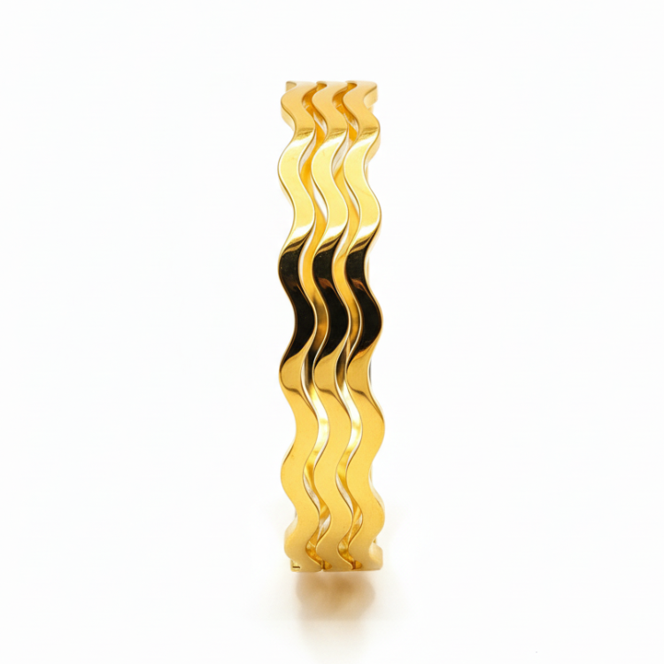 OSHAS Golden Wave Bangle close-up showing luxurious wavy texture and brilliant gold finish