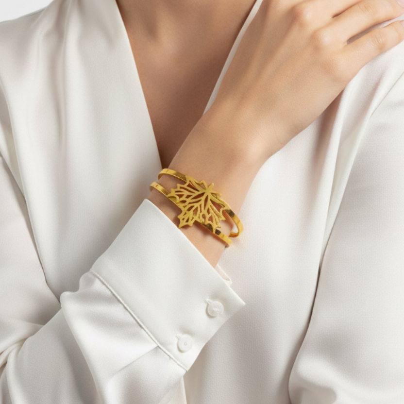 Elegantly Dressed Model Wearing Gold Maple Leaf Bracelet