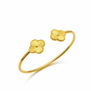 Golden Clover Bangle angled view displaying luxury gold finish and decorative clover ends
